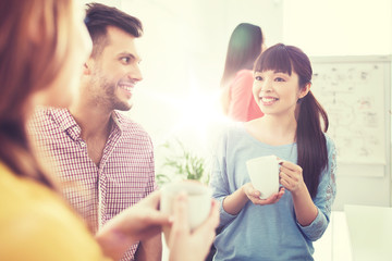 Canvas Print - happy creative team drinking coffee at office