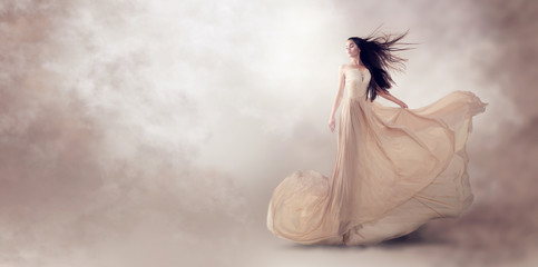 fashion model in beautiful luxury beige flowing chiffon dress