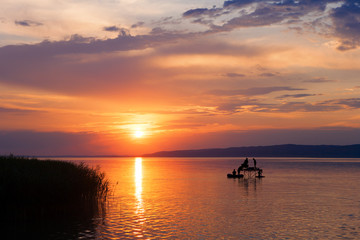 Canvas Print - Sunset over Lake Balaton with anglers' silhouettes in Hungary