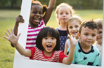 Group of kindergarten kids friends playing playground fun and smiling