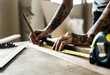 © Rawpixel.com - Carpenter using pencil and measurement tape on wood