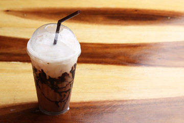 ice Mocha coffee on wood floor