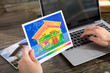 © Andrey Popov - The Person Detecting Heat Loss Of A House Using Laptop