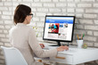 © Andrey Popov - Businesswoman Reading News On Computer