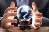 Fototapeta  - Businessman Covering Crystal Ball With Question Mark