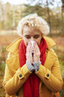 © gpointstudio - Picture of sneezing woman with tissue in hands .