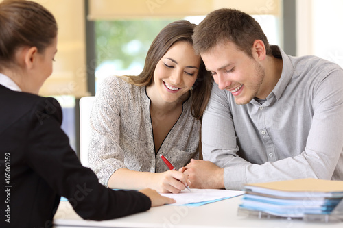 Cuadros en Lienzo Happy couple signing a contract at office