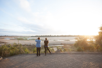 Two women look out over the Sabie river in Kruger National Park in South Africa