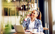 © dusanpetkovic1 - Young pretty businesswoman talking on the phone in coffee shop.
