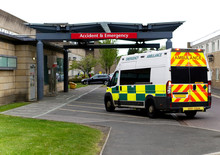 An Ambulance Drives Into An Accident & Emergency Ward Of A Hospital
