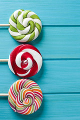 Sticker - Tasty colorful candies on wooden background