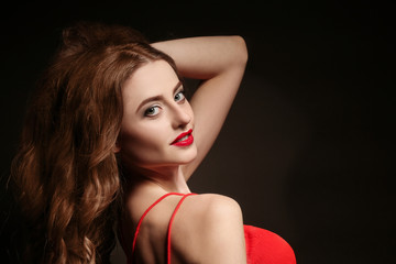 Poster - Beautiful young woman with bright lips on black background