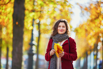 Wall Mural - Beautiful young girl in autumn park