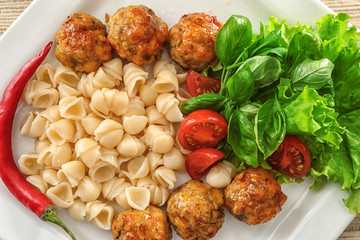 Sticker - Plate with turkey meatballs, pasta and vegetables on table, closeup