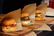 Delicious Burgers On Craft Paper, Serving Bbq At Open Grill, Outdoor Kitchen. Food Festival In City. Tasty Food Roasting, Food-court. Summer Picnic