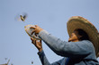 © Hugh Sitton/Stocksy - Woman releasing bird from cage at buddhist temple. Vietnam.