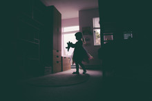 Little Girl Dancing In Her Room In Silhouette.