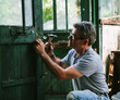 © kkgas/Stocksy - Man working on a wooden door