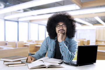 Wall Mural - African student with laptop and books