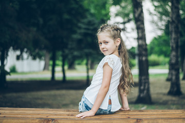 cute little blond girl in summer clothes outdoor