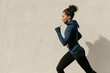 © Artem Varnitsin - Side view of female athlete running outdoors, cropped shot