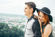 © phpetrunina14 - couple standing on the hill hugging and looking on city view