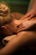 © Lumina/Stocksy - Woman receiving a neck massage at spa