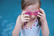 © Natalie JEFFCOTT/Stocksy - A young girl is excited to jump into a swimming pool in summer
