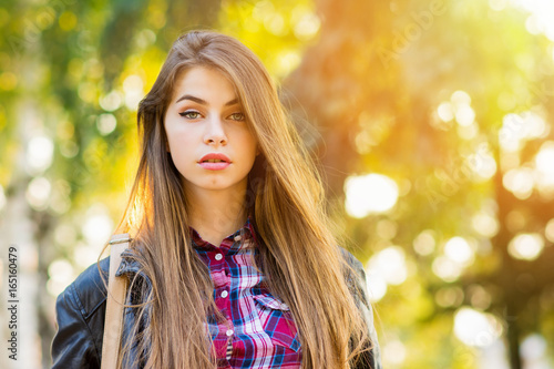 Beautiful Teenage Girl With Long Blonde Hair In Park In Autumn