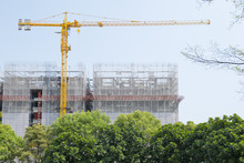 A Crane And Unfinished Building In Day