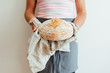 © Suzi Marshall/Stocksy - Woman holding a loaf of sourdough bread