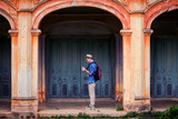 Fototapeta Na drzwi - An adult handsome man touring in ancient architecture French style village in Tharae Sakon Nakhon