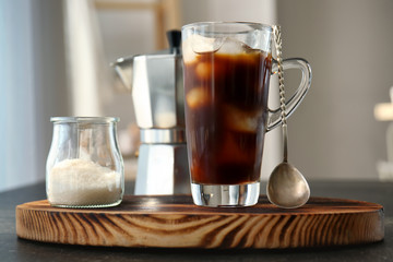 Poster - Glass cup with cold brew coffee and sugar bowl on cutting board