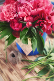 Fototapeta Tulipany - Beautiful peonies on wooden table in flower shop