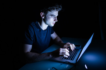Technology internet communication and people concept young man  with laptop computer in the night time