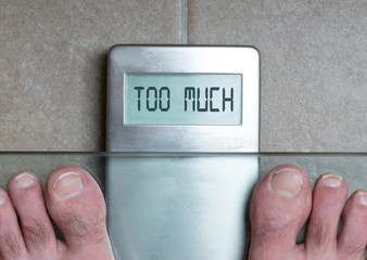 Man's feet on weight scale - Too much