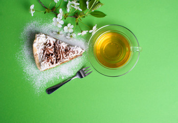 cake with tea on green background