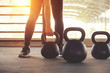 © oatawa - Fitness training with kettlebell in sport gym with sunlight effect.