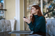 © SHOTPRIME STUDIO - Beautiful young woman sitting in a cafe on a street in the city