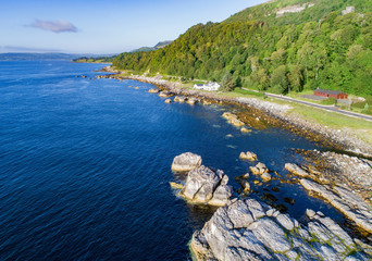 Wall Mural - The eastern coast of Northern Ireland and Antrim Coastal Road, a.k.a. Causeway Coastal Route. Aerial view at sunrise