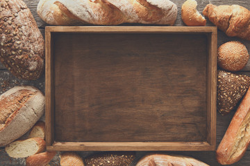 Wall Mural - Bread bakery background. Brown and white wheat grain loaves comp