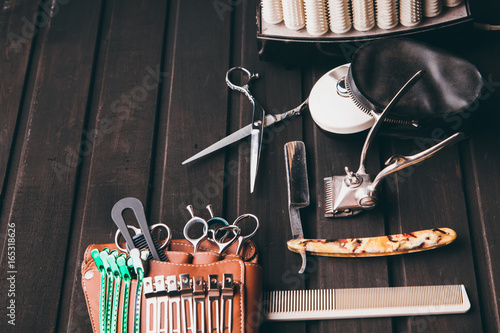 Fotografie, Obraz Beautiful professional tools professional Barber kits, scissors, a sharp razor, mechanical and electronic hair clippers, hair curlers, clips