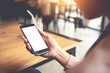 © oatawa - Close up of women's hands holding smart phone with blank copy space white screen for create content.