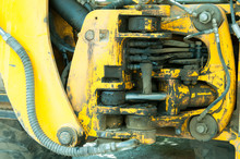 Close Up Of Dirty Yellow Excavator Bulldozer Hydraulic System Preasure Tubes Parts With Oil Leaks.