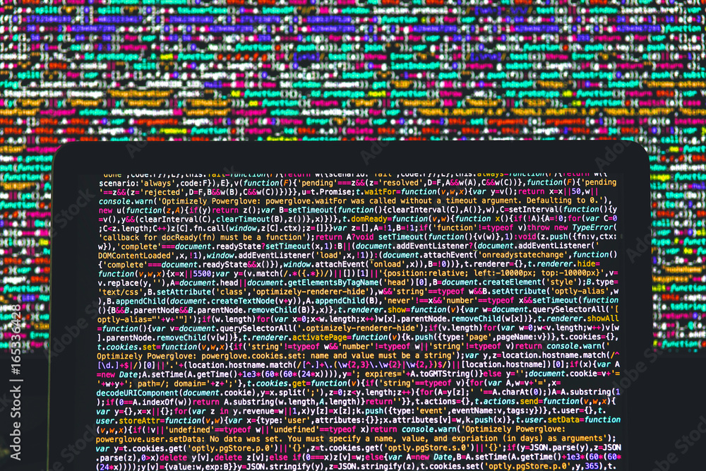 Laptop screen with source code in front of the bigger display Stock ...