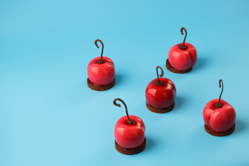 Wall Mural - Glossy mousse cakes in the form of cherries