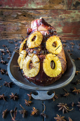 Wall Mural - Festive Baked ham with pineapples and cloves in rustic setting