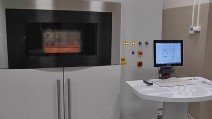 Wall Mural - Metal 3D printers. Direct metal laser sintering is an additive manufacturing technique that uses a Ytterbium fibre laser fired into a bed of powdered metal