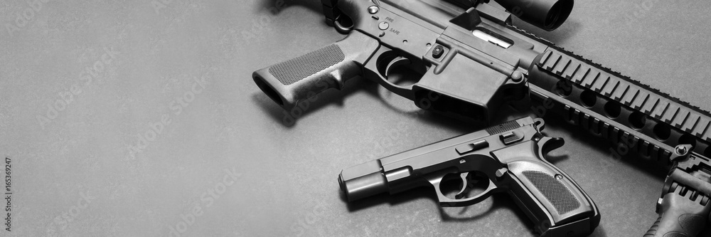 Assault rifle with handgun on gray background with copy space. Military ...