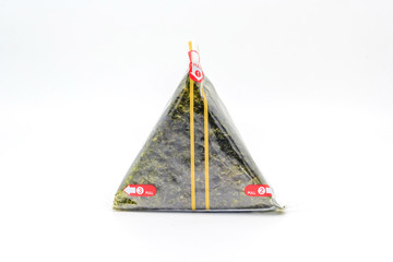 Portable Onigiri a Japanese rice ball wrapped with seaweed in sealed plastic on white background, with Copy space and text.